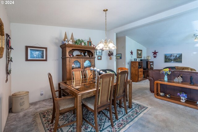 carpeted dining room with an inviting chandelier and vaulted ceiling with beams