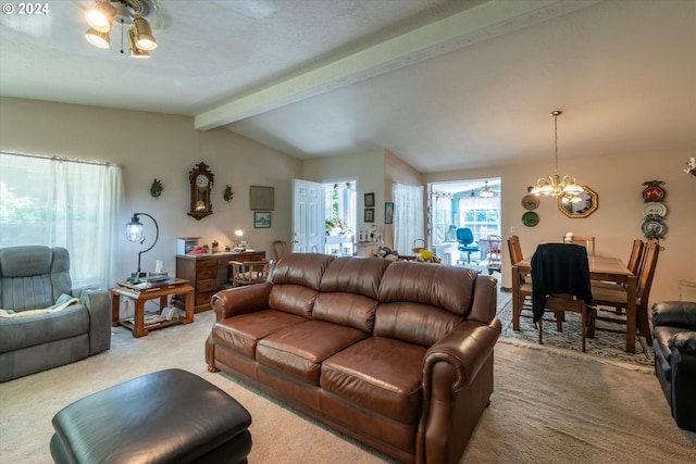 carpeted living room with ceiling fan with notable chandelier and vaulted ceiling with beams