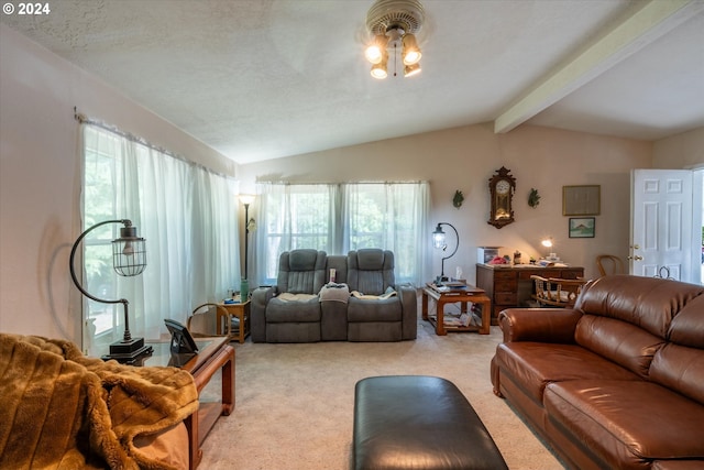 living room featuring lofted ceiling with beams, light colored carpet, and a textured ceiling