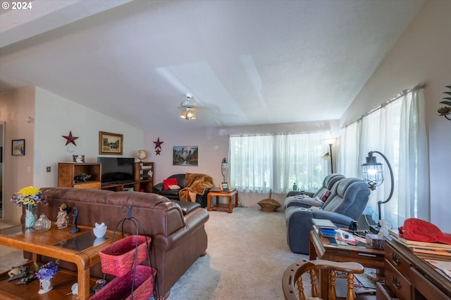 carpeted living room with lofted ceiling with skylight