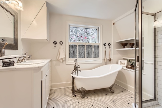 bathroom featuring tile patterned flooring, vanity, and a bath