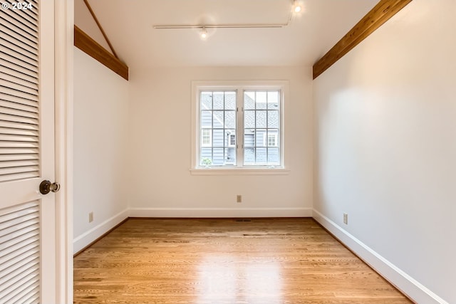 interior space with rail lighting and light hardwood / wood-style flooring