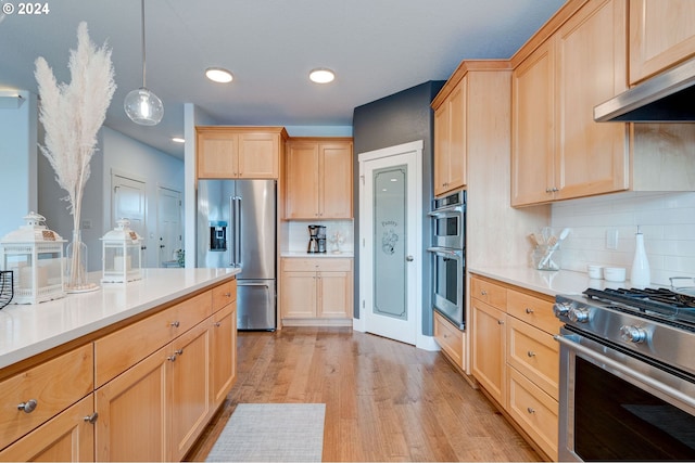 kitchen featuring decorative light fixtures, light hardwood / wood-style flooring, decorative backsplash, light brown cabinetry, and appliances with stainless steel finishes