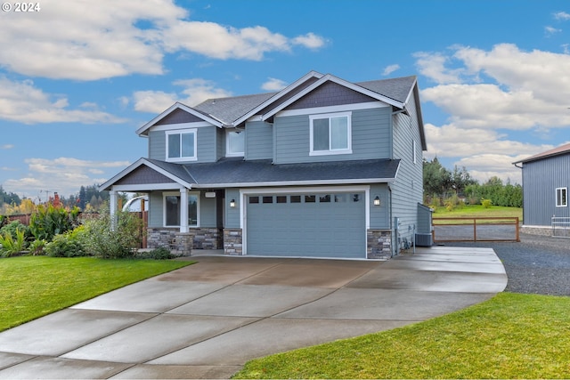 craftsman house featuring a porch, central AC, a front lawn, and a garage