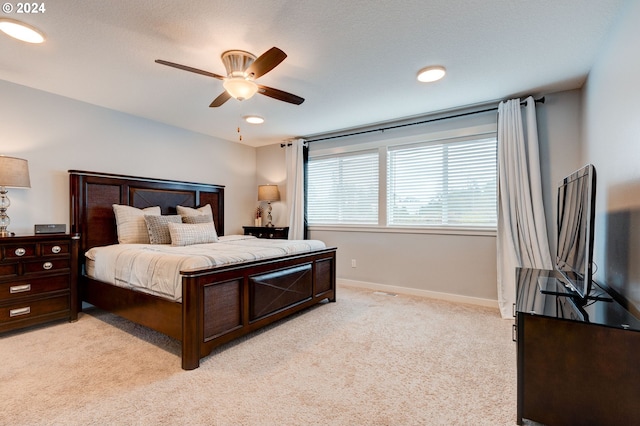 bedroom with ceiling fan and light carpet