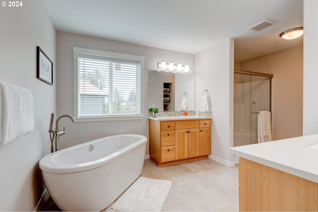 bathroom with separate shower and tub and vanity