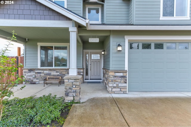 doorway to property with a garage