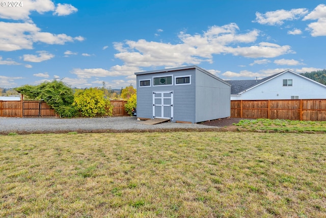 view of outbuilding featuring a lawn