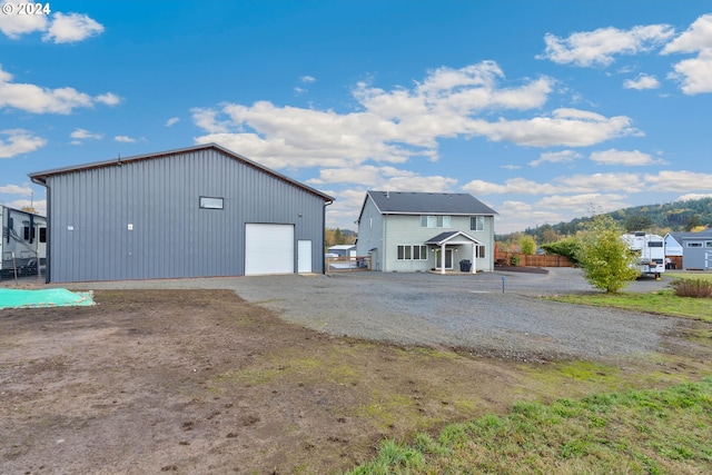 exterior space featuring a garage and an outbuilding