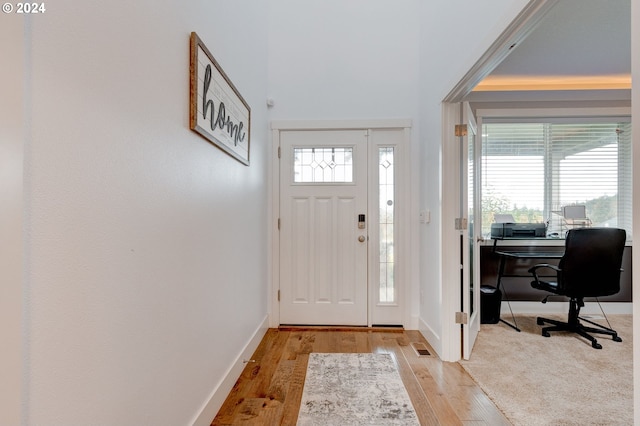 foyer entrance with light hardwood / wood-style flooring