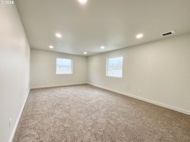 carpeted empty room featuring a healthy amount of sunlight