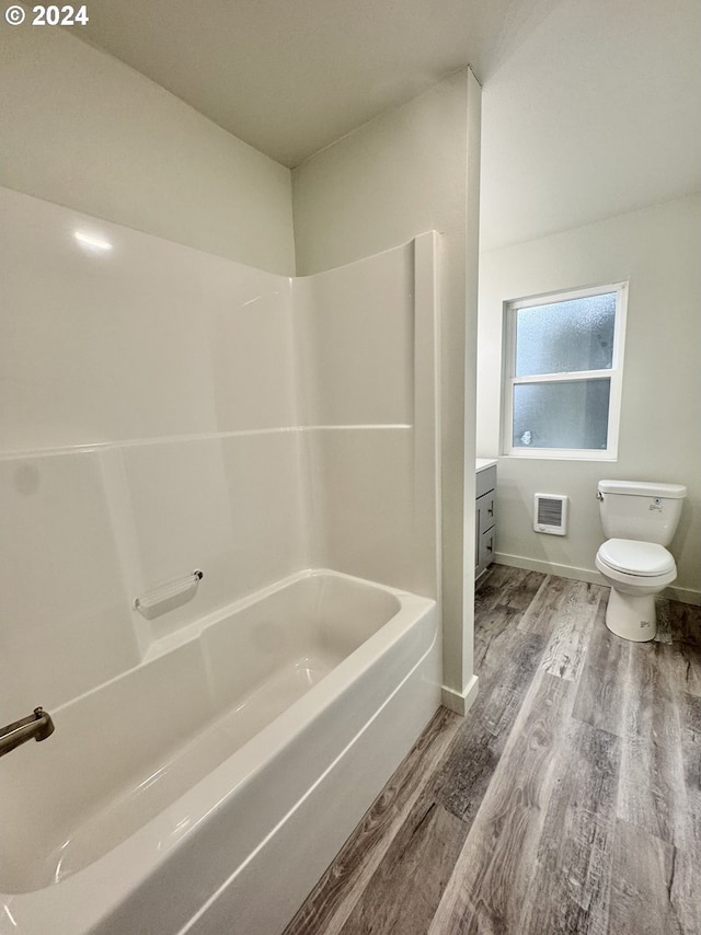 full bathroom with wood-type flooring, vanity, toilet, and tub / shower combination