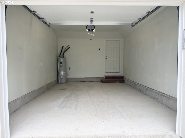 garage featuring electric water heater and a garage door opener