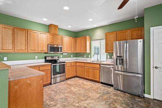 kitchen with ceiling fan, sink, and stainless steel appliances