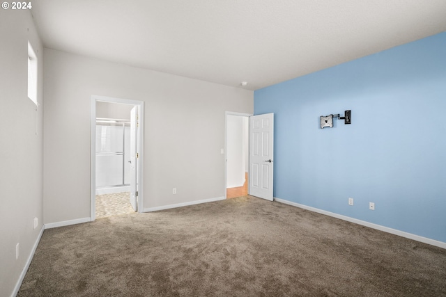 unfurnished bedroom with a spacious closet, carpet floors, and a closet