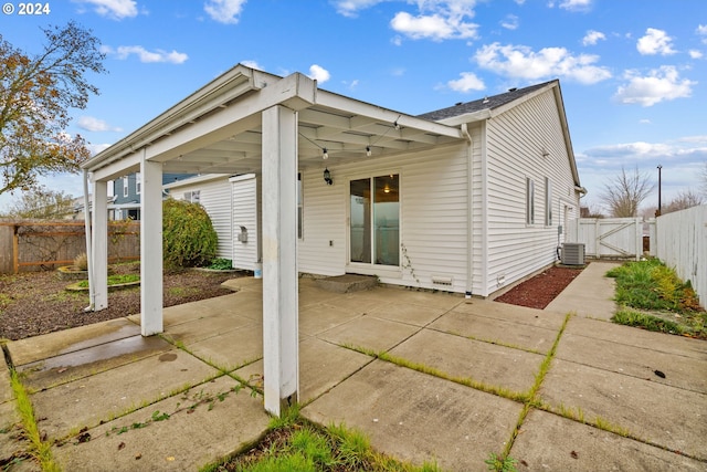 back of property featuring cooling unit and a patio area