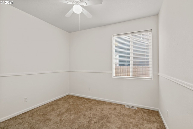 spare room with carpet flooring and ceiling fan