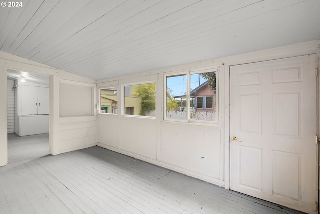 unfurnished sunroom with vaulted ceiling