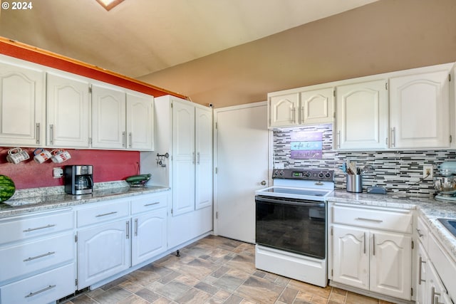 kitchen with white cabinets, vaulted ceiling, backsplash, light stone countertops, and white range with electric cooktop