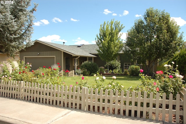 view of front of house featuring a garage and a front lawn