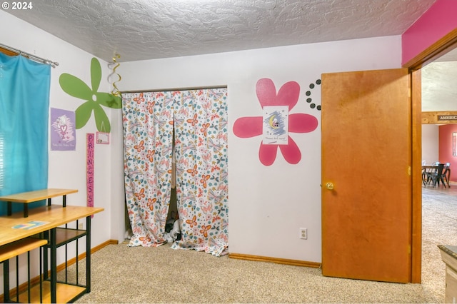 bedroom featuring carpet floors and a textured ceiling