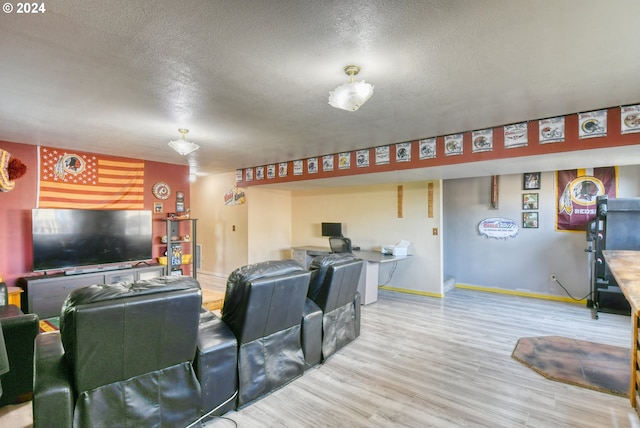 living room with a textured ceiling and hardwood / wood-style flooring