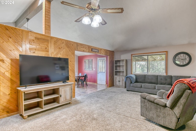 living room featuring lofted ceiling with beams, wood walls, ceiling fan, and light colored carpet