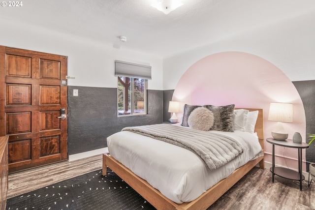 bedroom featuring wood finished floors and baseboards