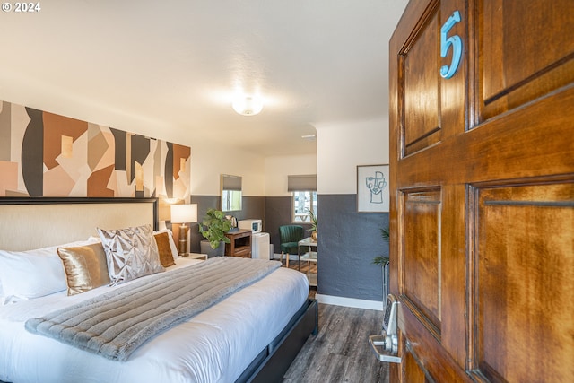 bedroom featuring dark wood finished floors and baseboards