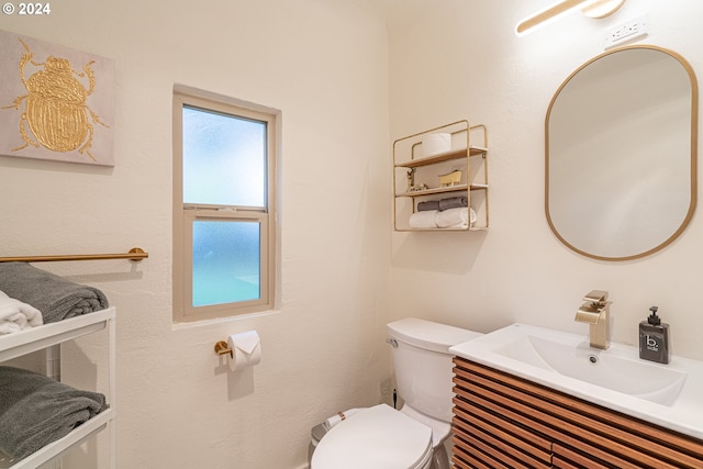 bathroom featuring toilet and vanity
