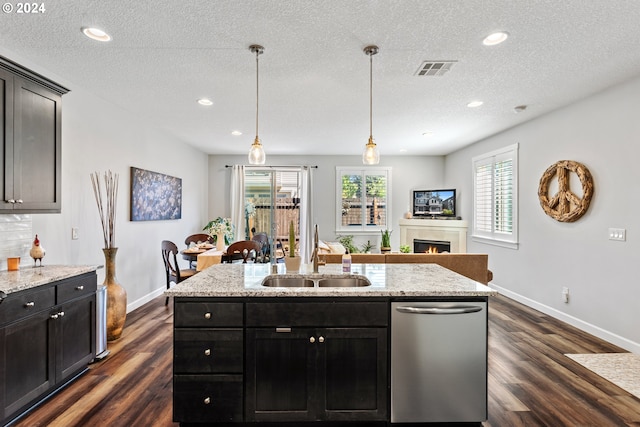 kitchen featuring sink, a textured ceiling, dark wood-type flooring, and dishwasher