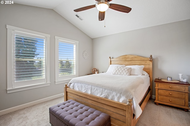 bedroom with ceiling fan, lofted ceiling, and light carpet