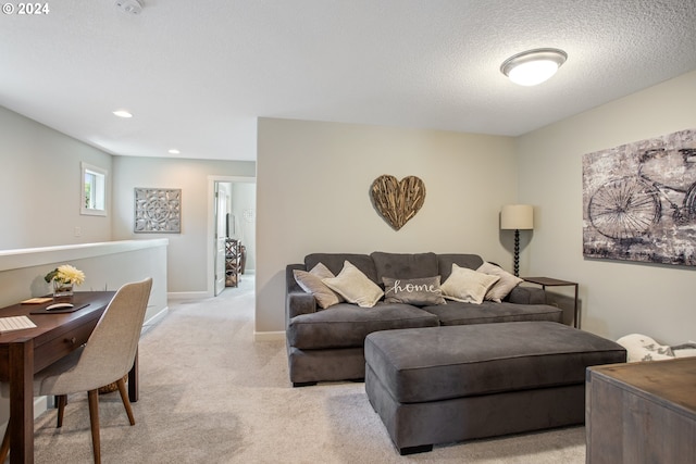 living room featuring light colored carpet and a textured ceiling