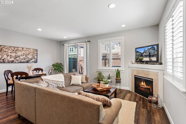 living room with dark wood-type flooring and a textured ceiling