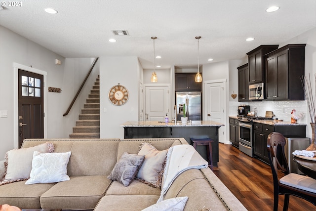 living room featuring dark hardwood / wood-style floors and a textured ceiling