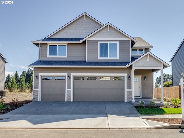 craftsman-style home with a garage and central air condition unit