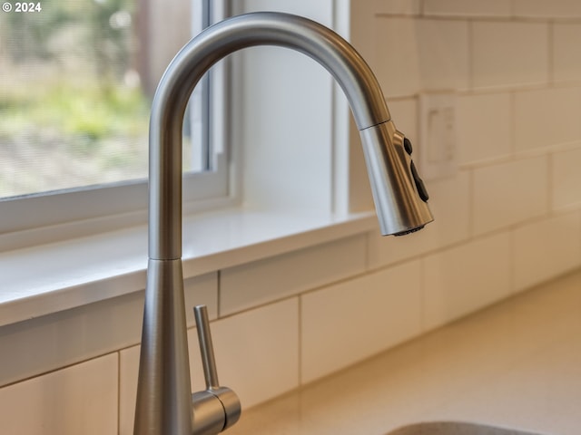 room details featuring white cabinetry and sink