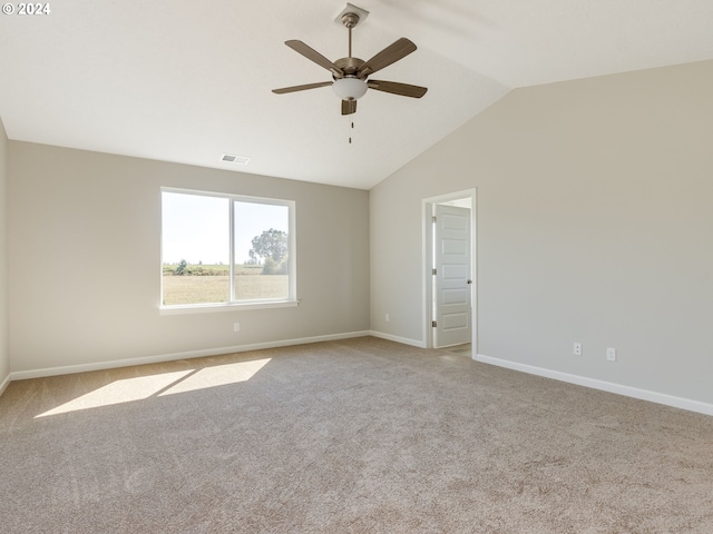 carpeted empty room featuring vaulted ceiling and ceiling fan