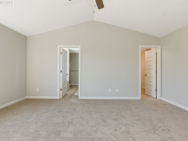 unfurnished bedroom with lofted ceiling, ceiling fan, and light colored carpet