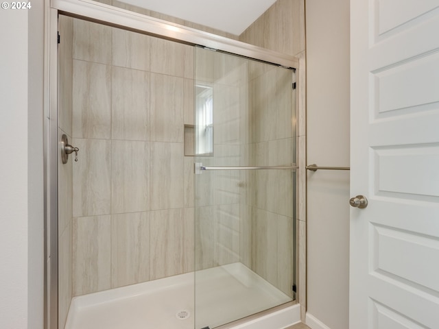 bathroom with a shower with shower door