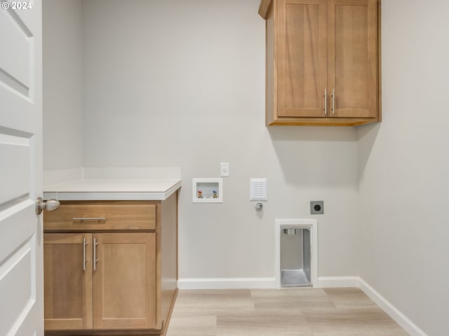 laundry room with washer hookup, cabinets, light wood-type flooring, and electric dryer hookup