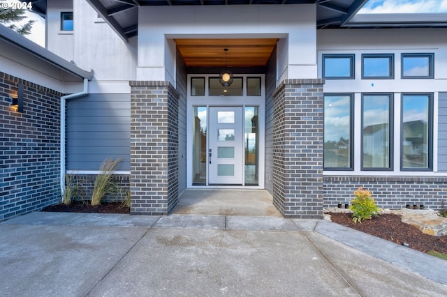 view of exterior entry with brick siding