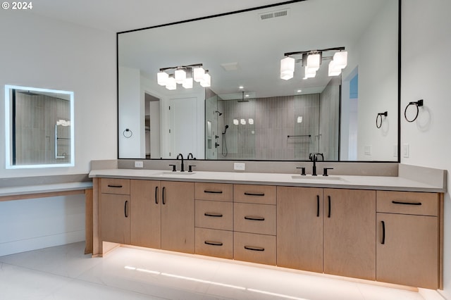 bathroom featuring vanity, a tile shower, and tile patterned flooring