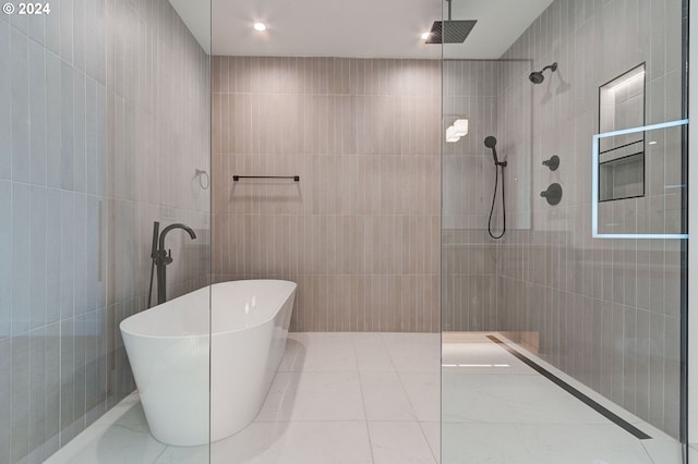 bathroom featuring independent shower and bath and tile walls