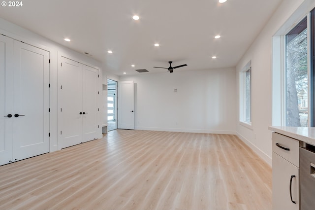 unfurnished living room with light hardwood / wood-style flooring and ceiling fan