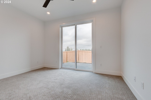 carpeted empty room featuring a wealth of natural light and ceiling fan