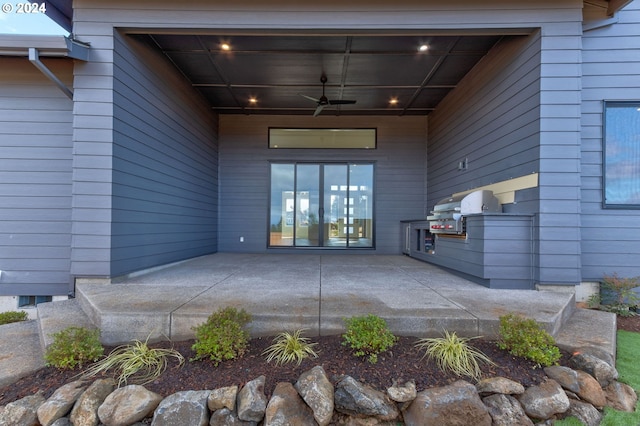 doorway to property with ceiling fan and a patio area