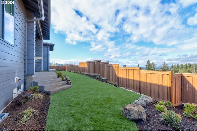 view of yard with a fenced backyard