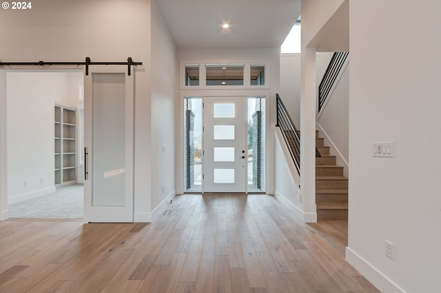 entrance foyer featuring light hardwood / wood-style flooring and a barn door