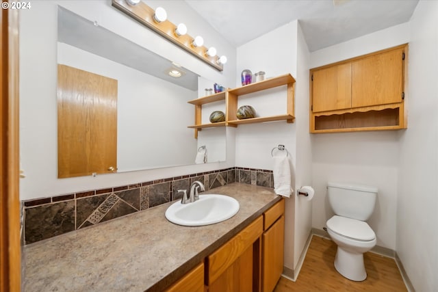 bathroom with vanity, wood-type flooring, and toilet